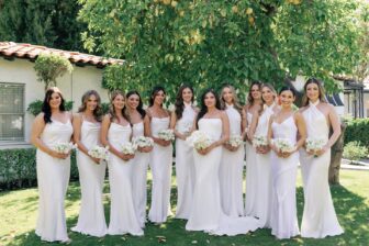 bridesmaids all in white gowns with flowers