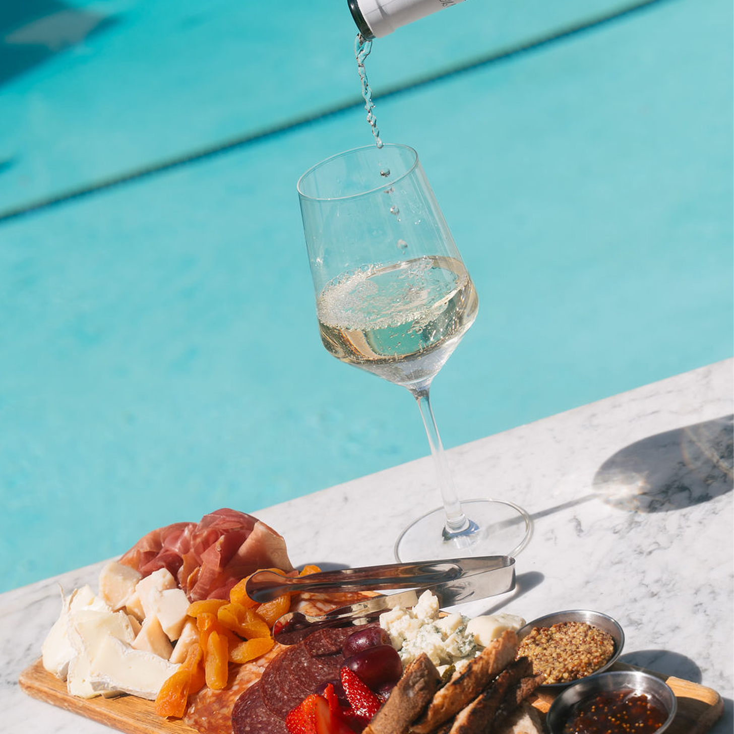 wine and cheese platter by pool